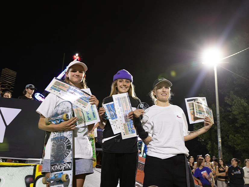 Young skateboarders holding up prizes at Moomba festival