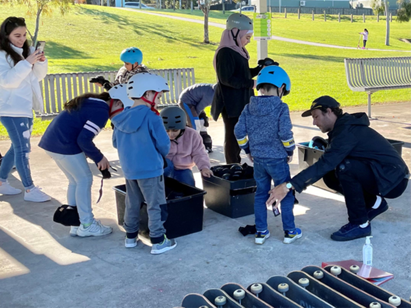 The Y Riverslide skateboarding instructor helping kids set up