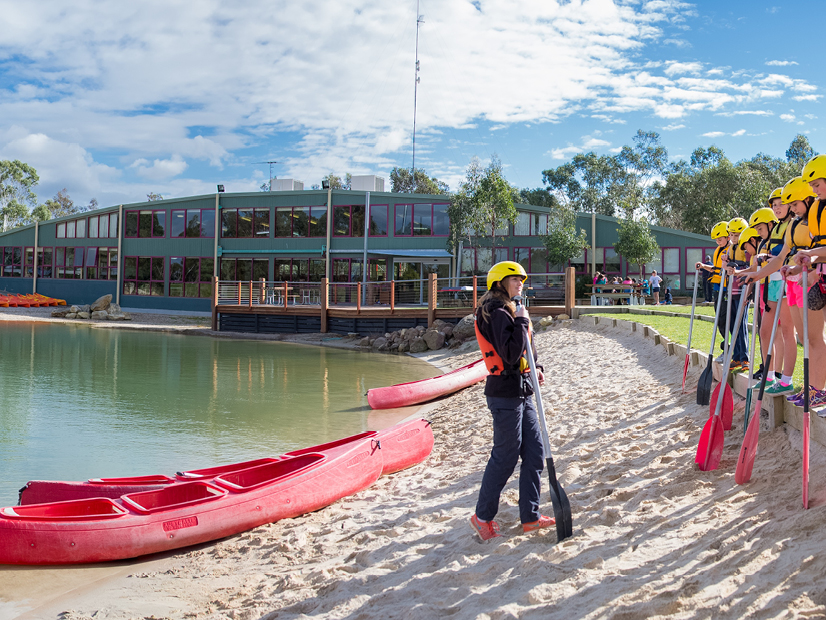 A group of participants are preparing to go canoeing on Lake Dewar.