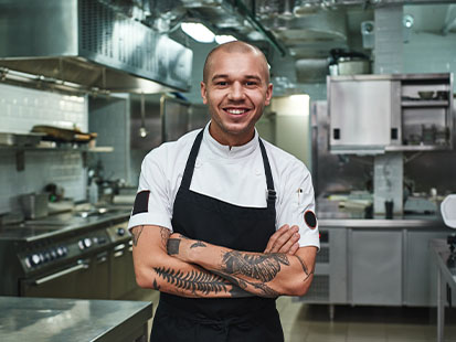 Chef cook posing for camera in kitchen