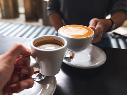Hands holding cups of coffee