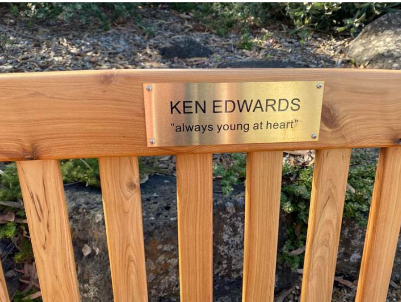 The Ken Edwards plaque on a memorial garden bench