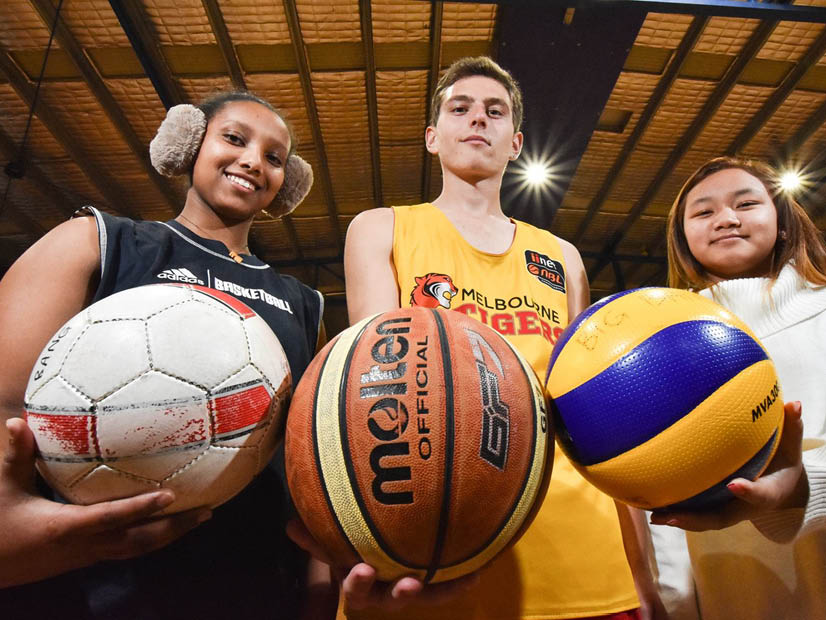 Three big bang sports program participants holding basketballs in the RecWest Braybrook stadium