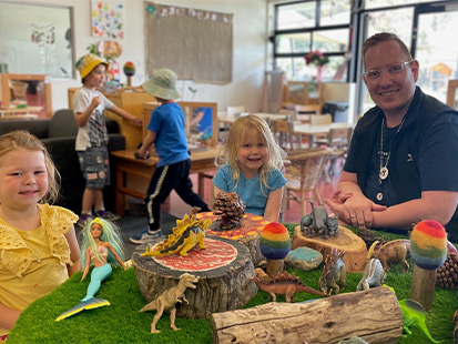 Point Cook centre manager Will Simpson sitting with children