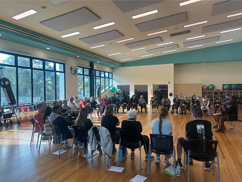 People sitting in circle for African Drumming workshop
