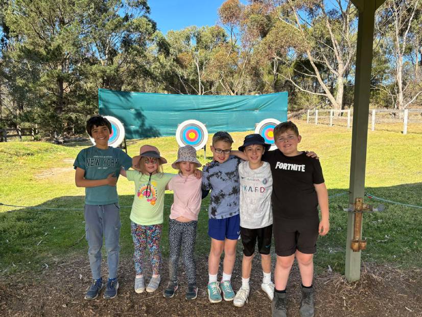 Kids in front of archery targets at the Y Lake Dewar Discovery Camp