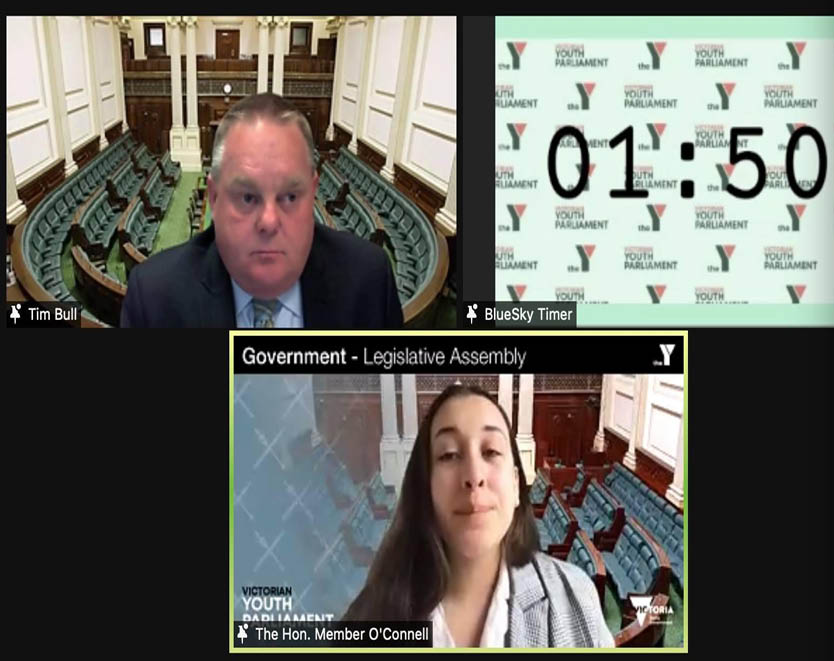 A youth parliamentarian speaking in the Legislative Assembly with The Hon. Tim Bull MP presiding. 