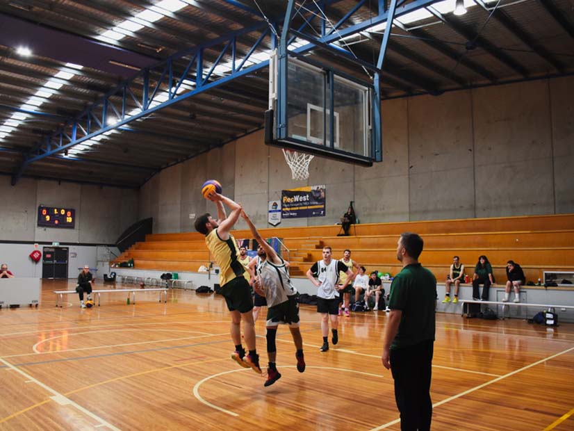 A RecWest Boomerang team member throws a basketball towards the hoop during a game
