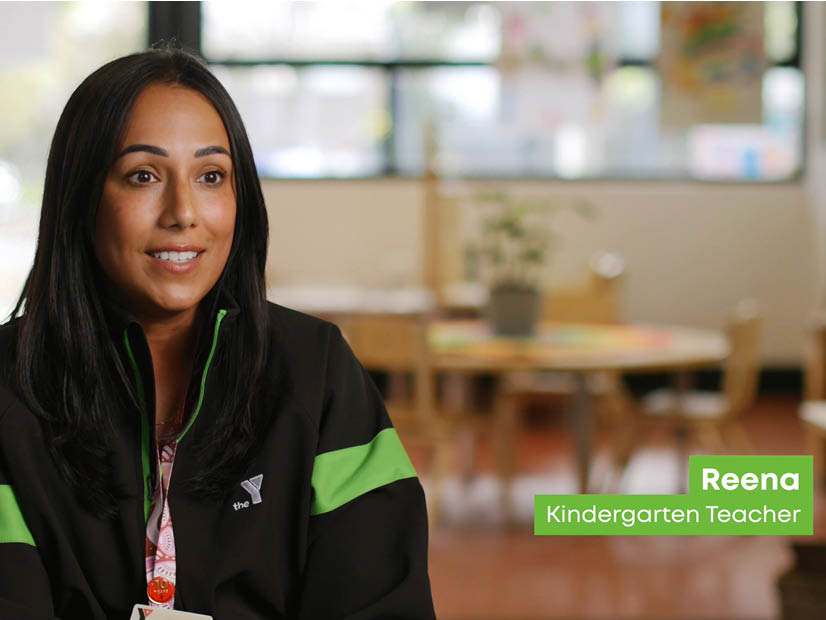 Rena, an Early Childhood Teacher at the Y smiling, wearing Y jacket at badge