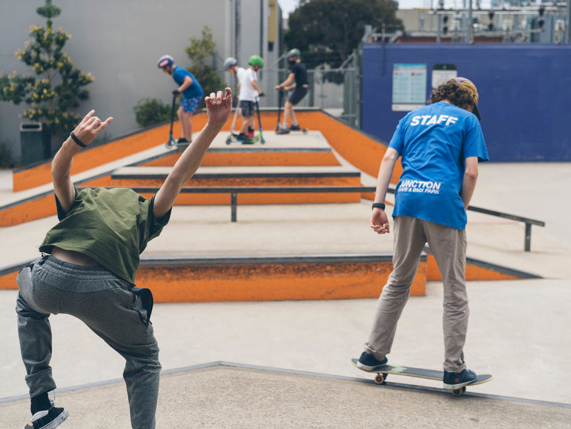 A content card image of a Junction Skate and BMX Park staff member riding a skateboard